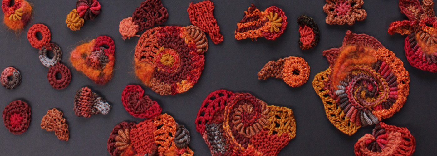 red and orange knitted and crocheted scrumbles